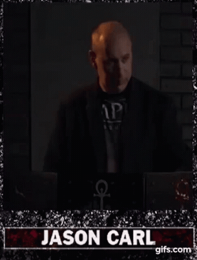 Bald Man In Suit Standing By Laptop GIF