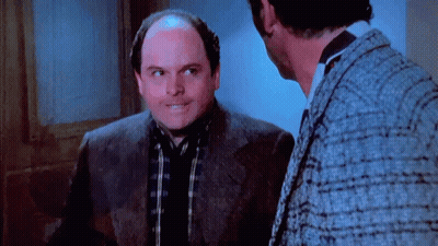 Bald Man In Suit Talking To Another Man GIF