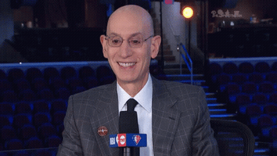 Bald Man In Suit Tie Smiling At Microphone GIF