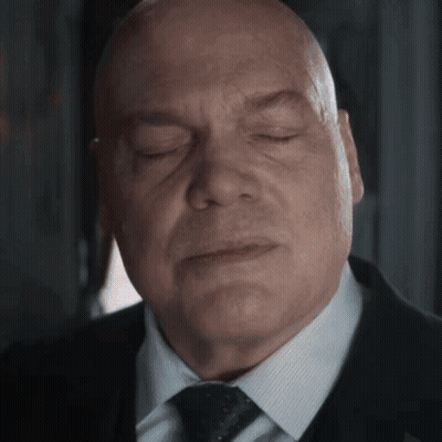 Bald Man In Suit With Eyes Closed GIF