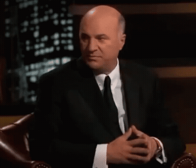 Bald Man In Suit With Hands Folded GIF