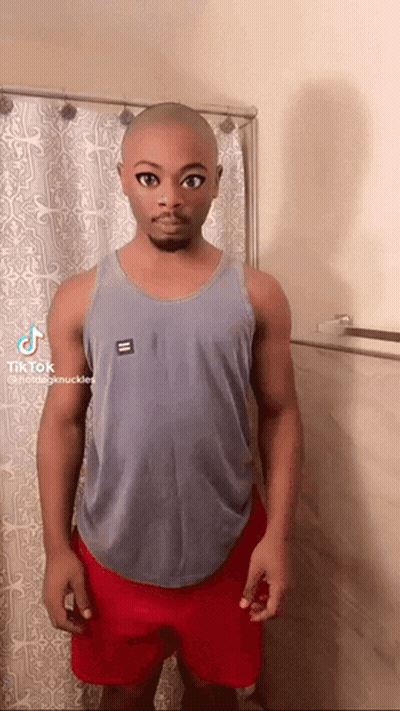 Bald Man In Tank Top And Red Shorts By Shower Curtain GIF