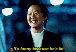 Bald Man In Tank Top Next To Man In Orange Vest GIF