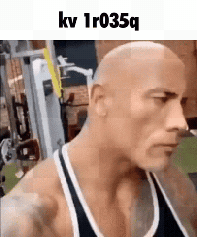 Bald Man In Tank Top Standing In Gym GIF