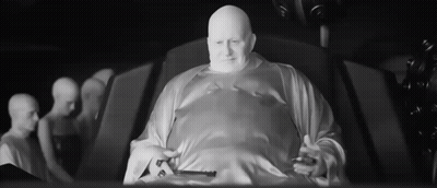 Bald Man In White Robe Sitting Black And White GIF