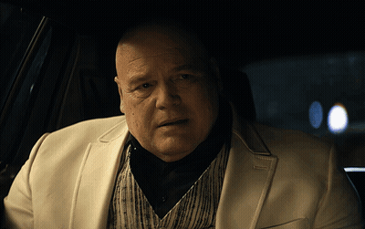 Bald Man In White Suit Sitting In Car GIF