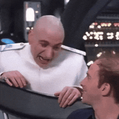 Bald Man in White Uniform Talking to Man
