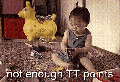 Bald Man Kneeling In Front Of Table With Sticker Saying A Few GIF
