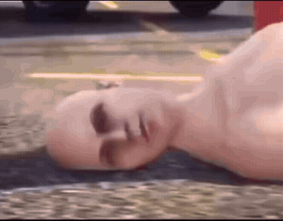 Bald Man Laying On Ground GIF
