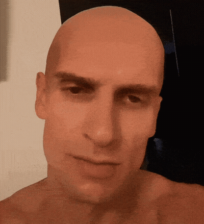Bald Man Looking At Camera GIF
