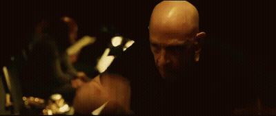 Bald Man Looking In Dark Room GIF