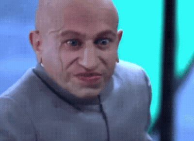 Bald Man Making Funny Face In Gray Suit GIF