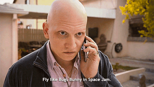 Bald Man On Phone With Fly Like Bugs Bunny In Space Jam GIF