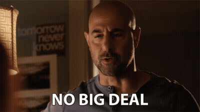 Bald Man Saying No Big Deal In Front Of Lamp GIF