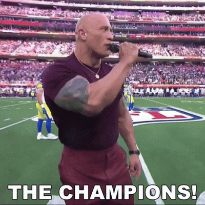 Bald Man Singing Into Microphone On Football Field Saying The Champions GIF