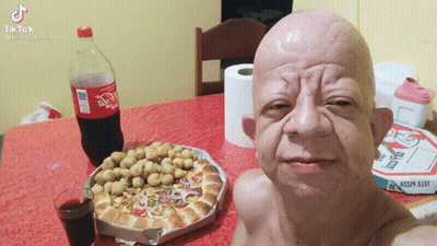 Bald Man Sitting At Table With Coca Cola And Pizza GIF