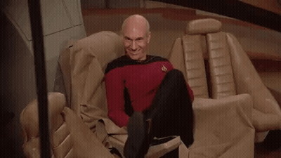 Bald Man Sitting Crossed Legs Smiling GIF
