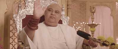 Bald Man Sitting In Chair With Microphone GIF