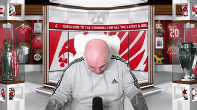 Bald Man Sitting In Front Of Subscribe Sign GIF