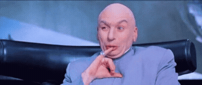 Bald Man Sitting With Finger To Mouth GIF