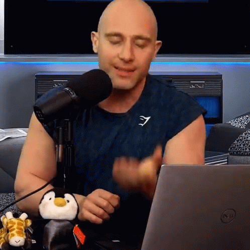 Bald Man Sitting With Stuffed Penguin GIF