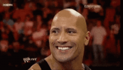 Bald Man Smiling At Wrestling Match GIF