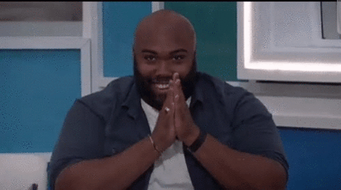 Bald Man Smiling Sitting On Couch GIF