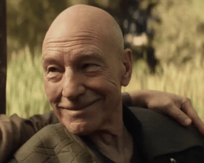 Bald Man Smiling With Arm Around Another Man GIF