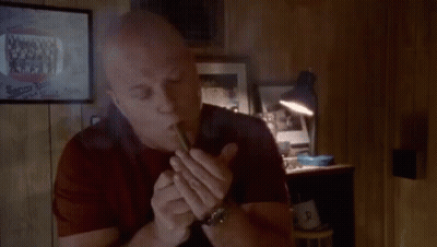 Bald Man Smoking Cigar By Lamp GIF