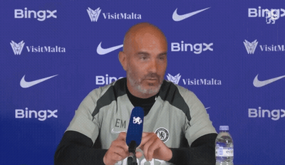 Bald Man Speaking Into Microphone In Front Of Bing Wall GIF