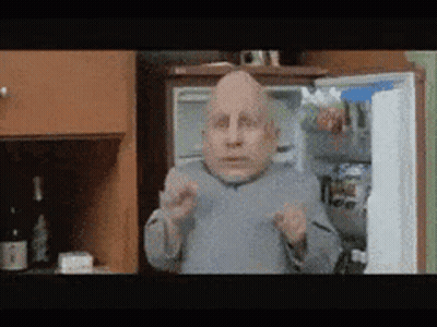 Bald Man Standing by Refrigerator