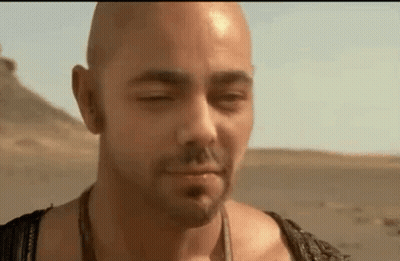 Bald Man Standing In Desert With Eyes Closed And Mouth Open GIF
