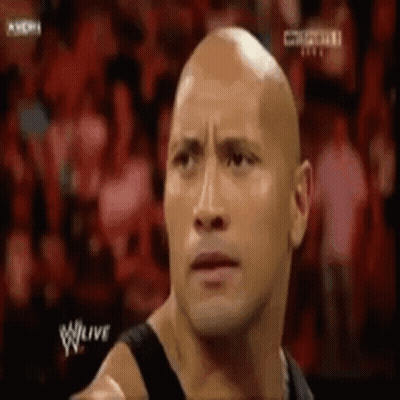 Bald Man Standing In Front Of Crowd GIF