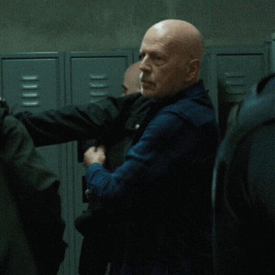 Bald Man Standing In Front Of Lockers GIF