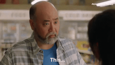 Bald Man Talking To Woman In Grocery Store Saying This GIF
