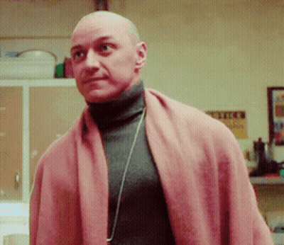 Bald Man Turtleneck Pink Scarf Looks At Camera GIF