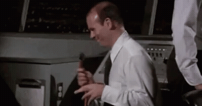 Bald Man White Shirt Black Tie Holding Hammer GIF