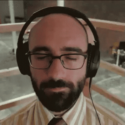 Bald Man With Beard And Glasses Wearing Headphones GIF