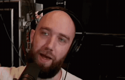 Bald Man With Beard And Headphones Talking Into Microphone GIF