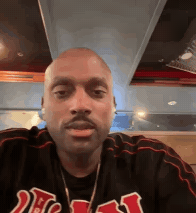 Bald Man With Beard In Striped Black Shirt GIF