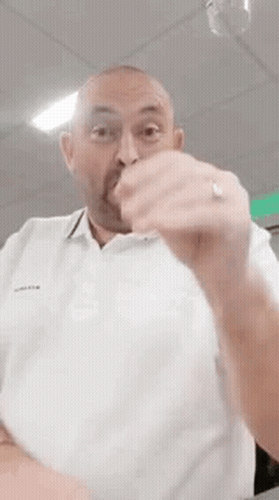 Bald Man With Beard Making Funny Face In White Shirt GIF