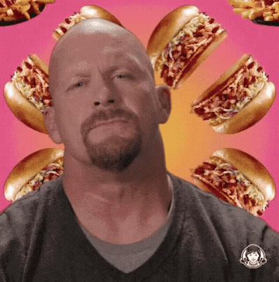 Bald Man With Beard Surrounded By Hot Dogs And Fries GIF