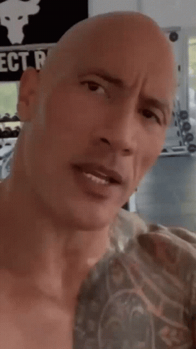 Bald Man With Chest Tattoo Looking At Camera GIF