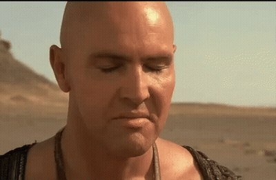 Bald Man With Eyes Closed In Desert GIF