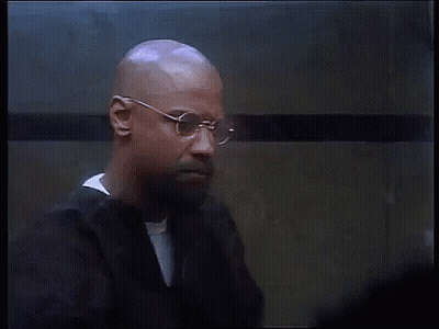 Bald Man With Glasses And Beard Standing In Front Of Wall GIF