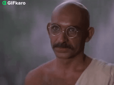 Bald Man With Glasses And Mustache In White Robe GIF