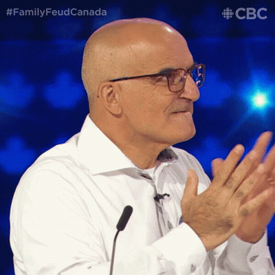 Bald Man With Glasses Applauding At Microphone FamilyFeudCanada GIF