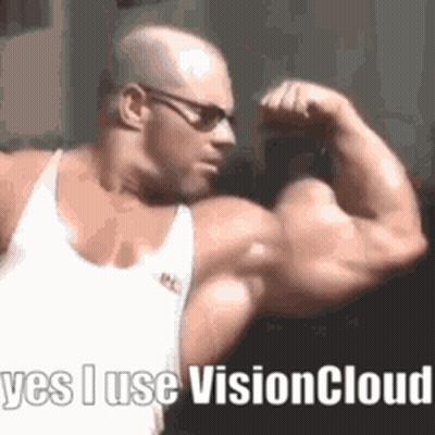 Bald Man with Glasses Flexing Muscles Says Vision Cloud