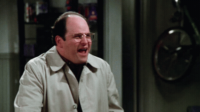Bald Man With Glasses In Trench Coat Laughing GIF