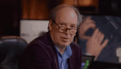 Bald Man With Glasses Sitting At Computer Desk GIF